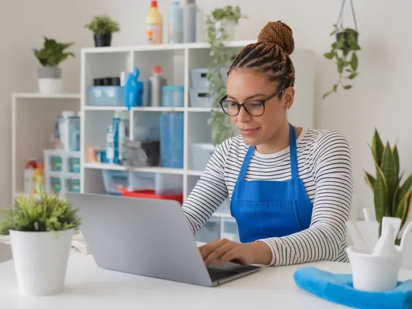 Cleaning business owner creating a free professional profile on laptop